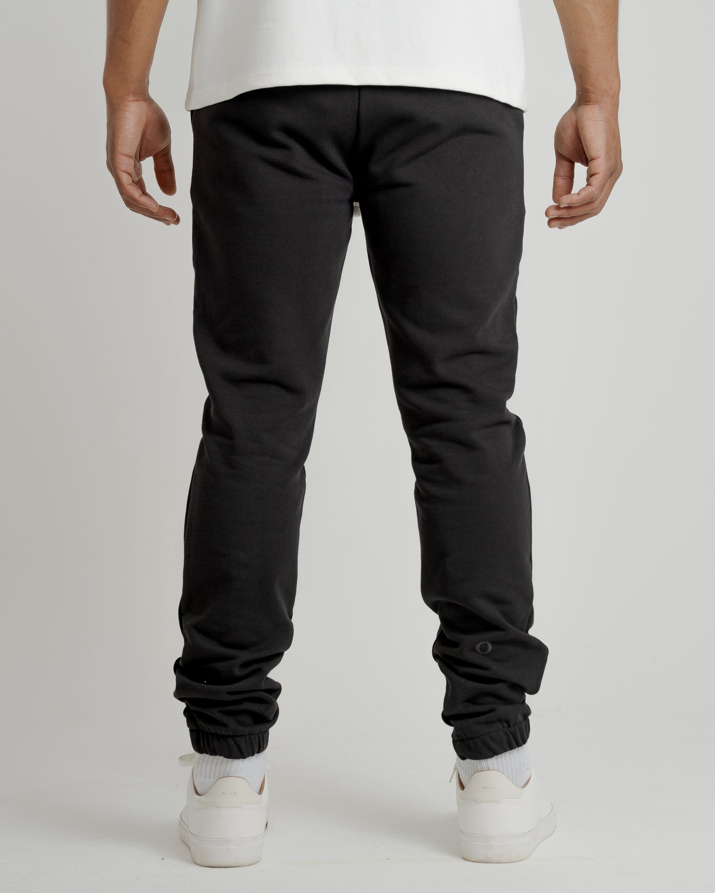 A male model showcasing our black sweatpants, combining comfort and style in a versatile wardrobe essential.