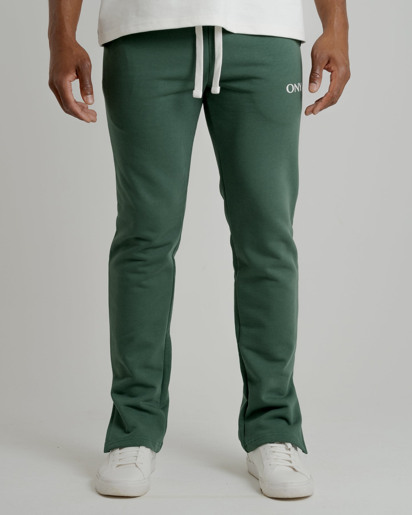 A male model wearing our green split sweatpants for a laid-back yet fashionable look.