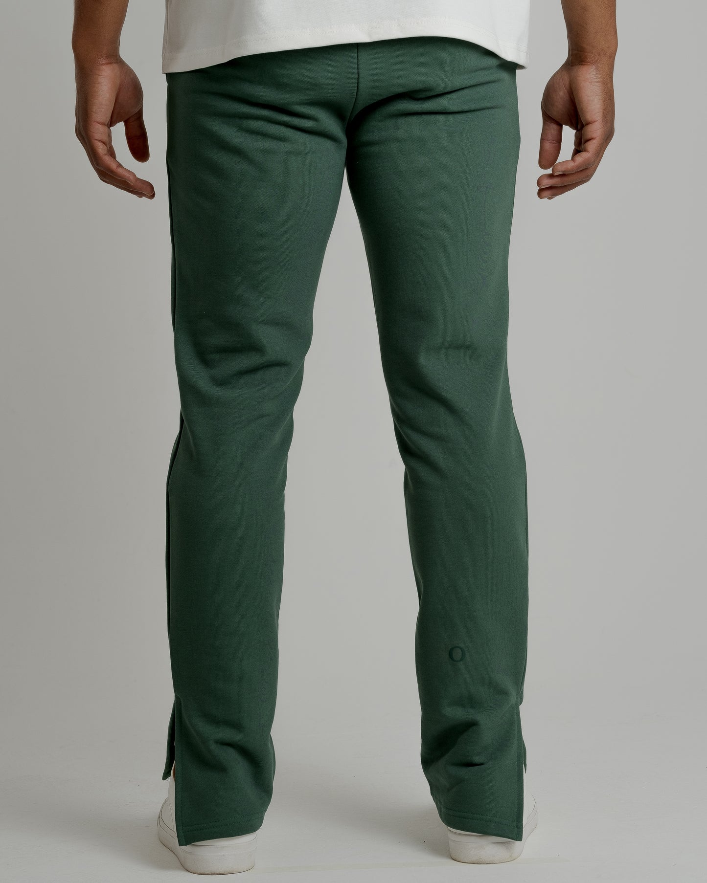 A male model wearing our grey split sweatpants for a laid-back yet fashionable look.