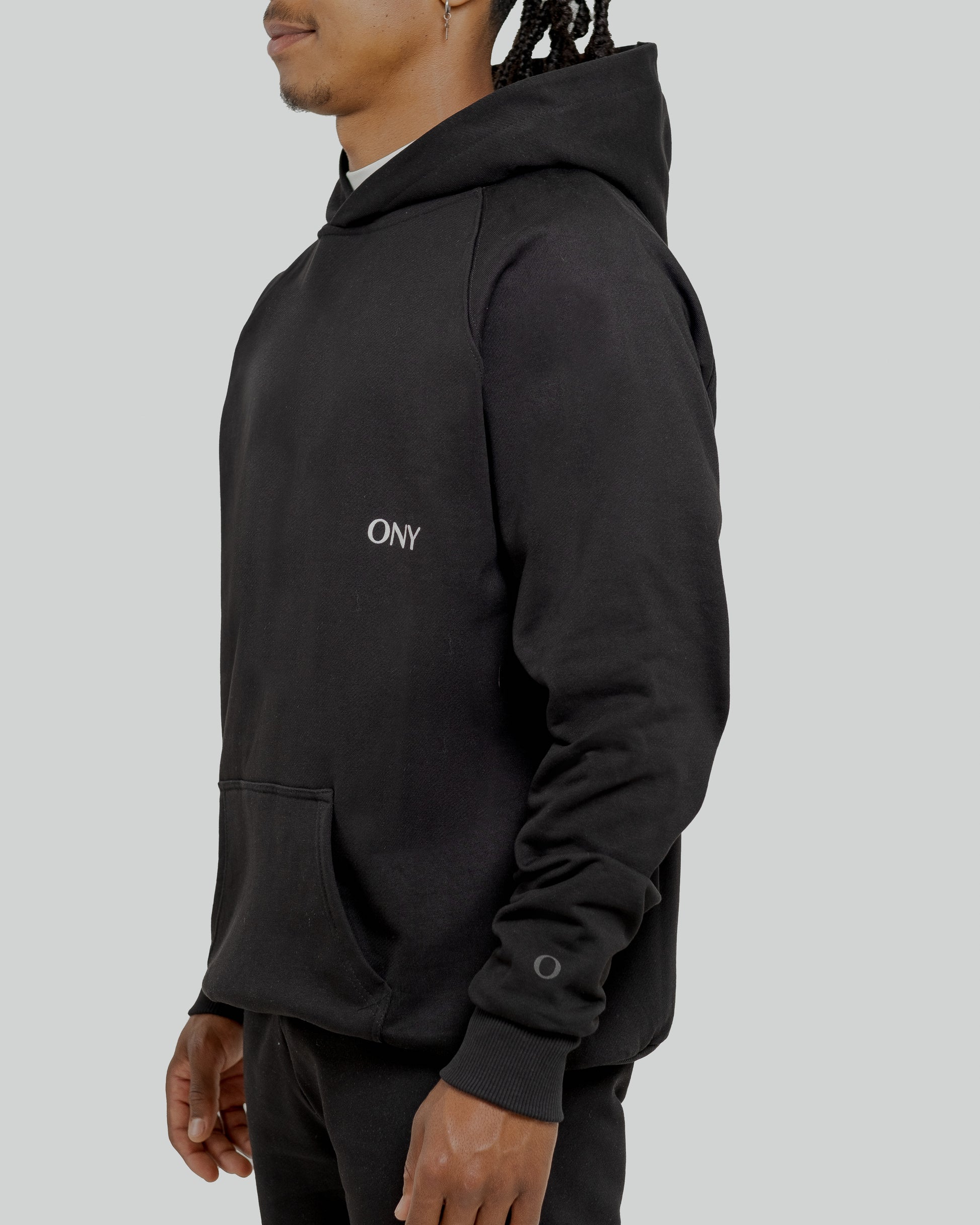 A male model wearing a stylish Black oversized hoodie, perfect for a comfortable and fashionable look.  