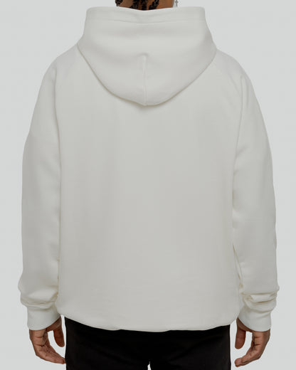 A male model wearing a stylish off-white oversized hoodie, perfect for a comfortable and fashionable look.  