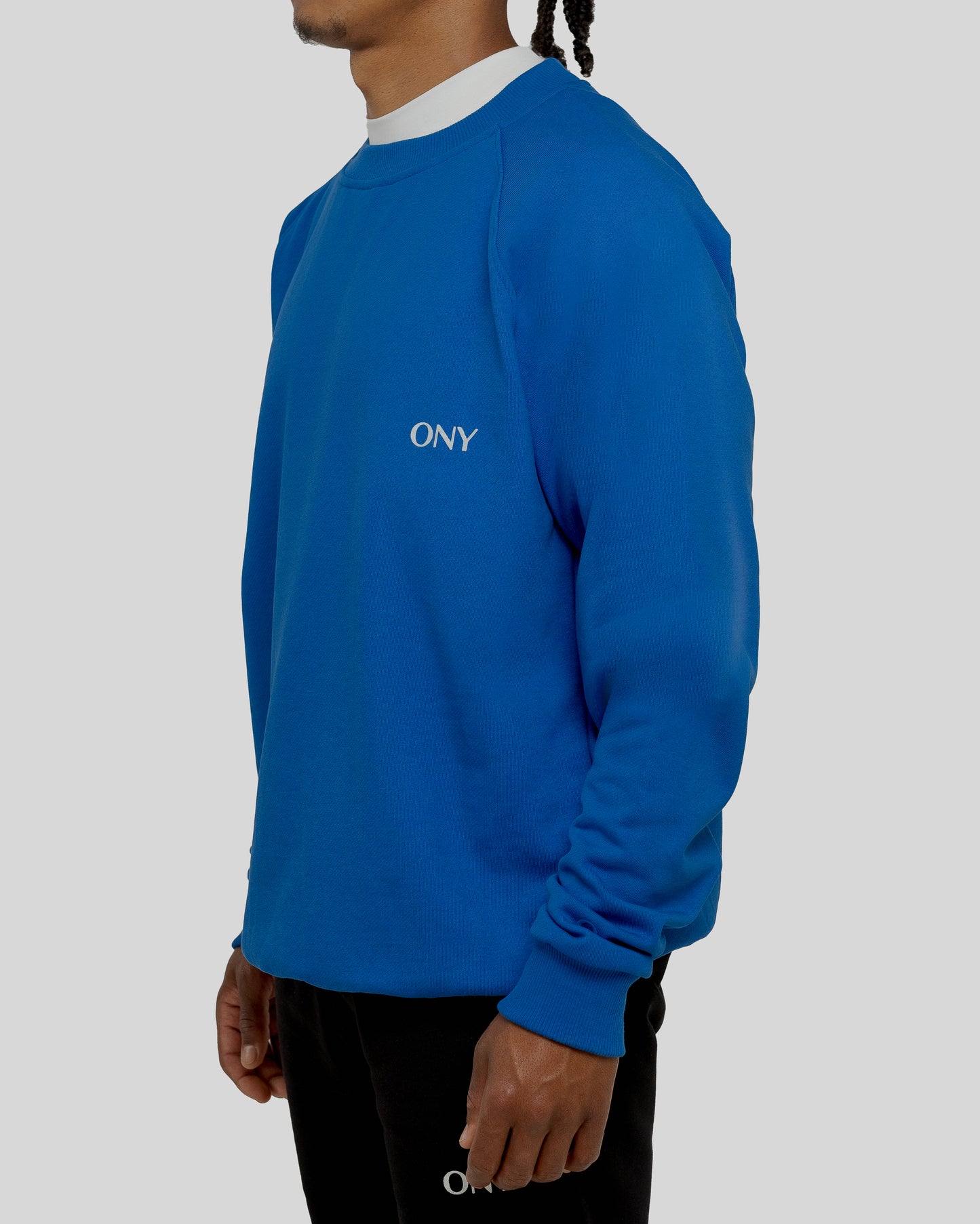 A male model wearing our blue oversized sweatshirt, exuding a casual and stylish vibe for a modern wardrobe.