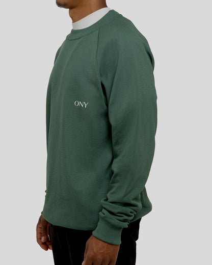 A male model wearing our green oversized sweatshirt, exuding a casual and stylish vibe for a modern wardrobe.