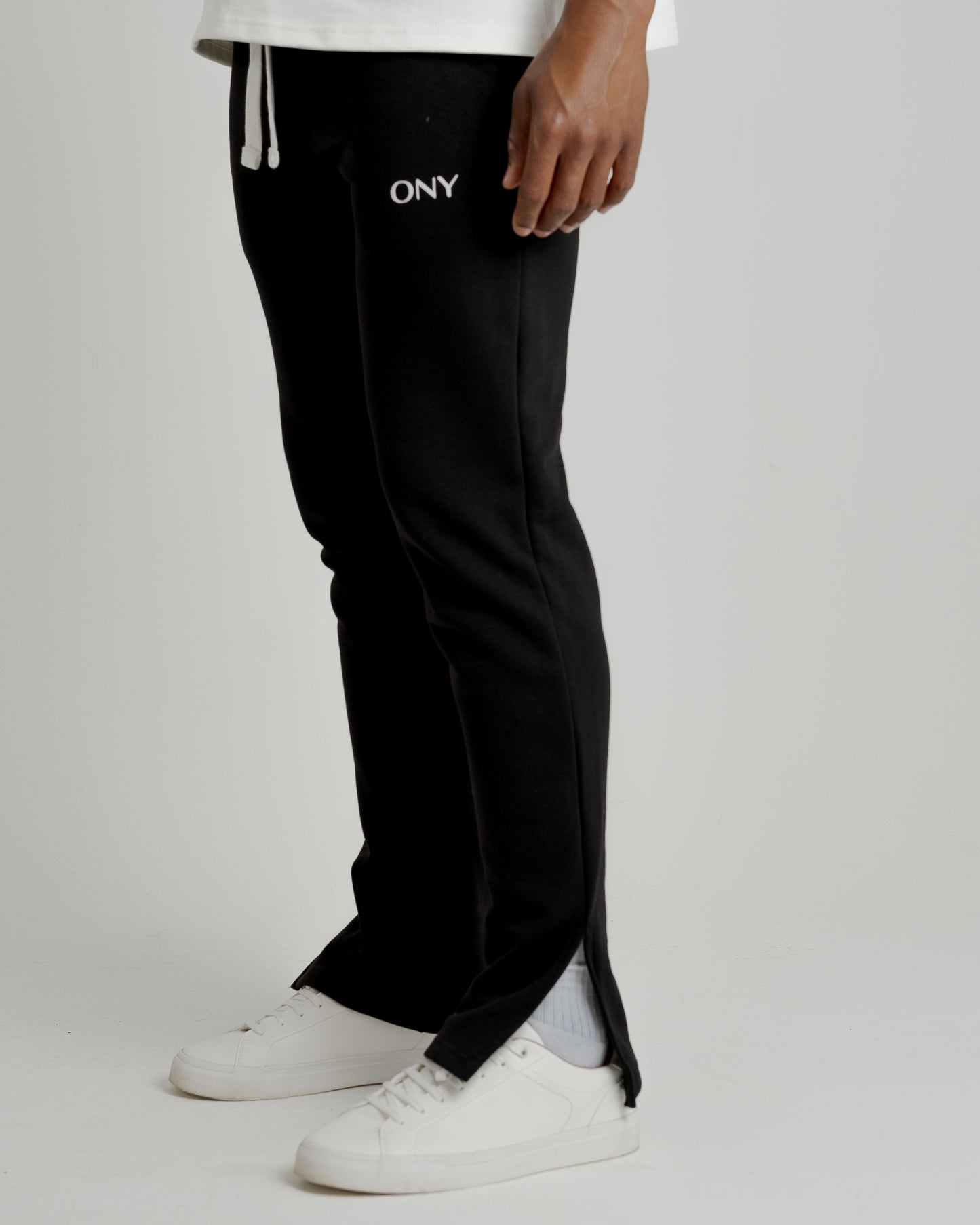 A male model wearing our black split sweatpants for a laid-back yet fashionable look.