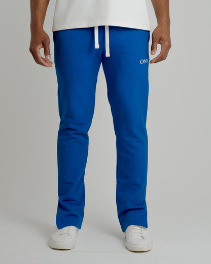 A male model wearing our blue split sweatpants for a laid-back yet fashionable look.