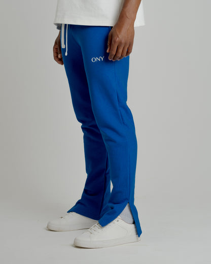 A male model wearing our blue split sweatpants for a laid-back yet fashionable look.