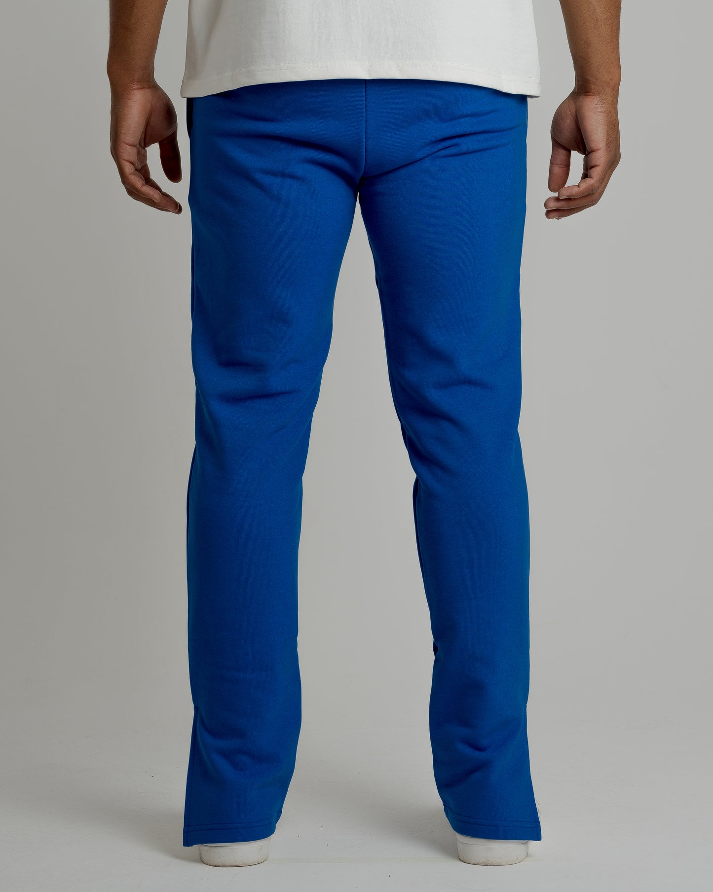 A male model wearing our blue split sweatpants for a laid-back yet fashionable look.