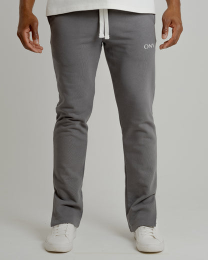 A male model wearing our grey split sweatpants for a laid-back yet fashionable look.