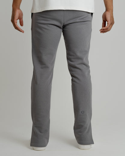 A male model wearing our grey split sweatpants for a laid-back yet fashionable look.